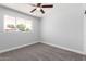 Clean bedroom with carpet, ceiling fan, and window offers a serene, comfortable retreat at 3126 W Stella Ln, Phoenix, AZ 85017