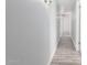 Hallway with wood-look tile flooring, lighting, and a view of storage at the end at 3126 W Stella Ln, Phoenix, AZ 85017