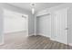 Bright hallway with gray wood-look tile flooring, white trim, and doorways to adjacent rooms at 3126 W Stella Ln, Phoenix, AZ 85017