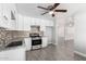 Bright kitchen with white cabinets, granite countertops, and stainless steel appliances at 3126 W Stella Ln, Phoenix, AZ 85017