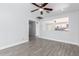 Bright living room featuring a pass-through to another room and gray wood-look tile flooring at 3126 W Stella Ln, Phoenix, AZ 85017