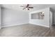 Bright living room showing a pass-through to another room and gray wood-look tile flooring at 3126 W Stella Ln, Phoenix, AZ 85017