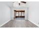Bright living room with wood-look tile flooring leads to a screened-in back patio at 3126 W Stella Ln, Phoenix, AZ 85017