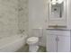 Bathroom with modern fixtures, tiled shower, and vanity sink with storage at 3126 W Stella Ln, Phoenix, AZ 85017