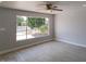 This light-filled bedroom has wood-look floors and a large window overlooking the front yard at 3126 W Stella Ln, Phoenix, AZ 85017