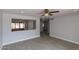 Spacious living room featuring wood-look tile flooring, ceiling fan and neutral walls at 3126 W Stella Ln, Phoenix, AZ 85017