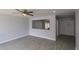 Spacious living room featuring wood-look tile flooring, ceiling fan and neutral walls at 3126 W Stella Ln, Phoenix, AZ 85017