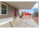 Covered carport area with concrete, steps to the home, and a view of surrounding properties at 320 E Mckellips Rd # 45, Mesa, AZ 85201