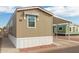 Tan home with a covered carport, window awning, and visible unit number 45 at 320 E Mckellips Rd # 45, Mesa, AZ 85201