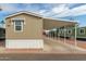 Tan exterior home with covered carport and well-maintained landscaping around the perimeter at 320 E Mckellips Rd # 45, Mesa, AZ 85201