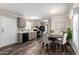 Open kitchen and dining area featuring black appliances, gray cabinets, and a dining table at 320 E Mckellips Rd # 45, Mesa, AZ 85201