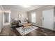 Cozy living room with modern furnishings, neutral color palette, and dark wood-look flooring at 320 E Mckellips Rd # 45, Mesa, AZ 85201