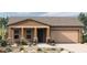 Charming single-story home features a cozy front porch, two-car garage, and low-maintenance desert landscaping at 32978 N 132Nd Ln, Peoria, AZ 85383