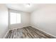 Bright bedroom with hardwood floors and window at 4833 N 63Rd Ln, Phoenix, AZ 85033