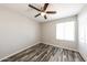 Bedroom with ceiling fan, hardwood floors, a window, and closet at 4833 N 63Rd Ln, Phoenix, AZ 85033
