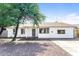 Charming single-story home featuring a well-maintained front yard and neutral color palette at 4833 N 63Rd Ln, Phoenix, AZ 85033
