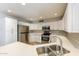 Bright kitchen featuring quartz countertops, stainless steel appliances, and ample storage at 4833 N 63Rd Ln, Phoenix, AZ 85033