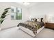 Bedroom featuring a plush bed with designer bedding, bright lighting, and a large window at 5250 E Deer Valley Dr # 140, Phoenix, AZ 85054
