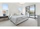 Bright main bedroom boasts large windows, plush carpet, and access to outdoor balcony at 5250 E Deer Valley Dr # 140, Phoenix, AZ 85054