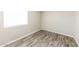 Bright bedroom with neutral walls, wood-look flooring, and bright window at 5533 W Sunnyside Dr, Glendale, AZ 85304
