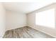 Bright bedroom with neutral walls, wood-look flooring, and bright window at 5533 W Sunnyside Dr, Glendale, AZ 85304