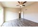 Comfortable bedroom with ceiling fan, adjacent closet, and sliding glass door to outside at 5533 W Sunnyside Dr, Glendale, AZ 85304