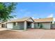 Inviting single-story home with a charming entrance and low-maintenance desert landscaping at 5533 W Sunnyside Dr, Glendale, AZ 85304