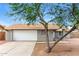 Charming single-story home featuring a two-car garage, painted brick, and low maintenance landscaping at 5533 W Sunnyside Dr, Glendale, AZ 85304