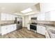 Bright kitchen with stainless steel appliances, granite countertops, and white cabinetry at 5533 W Sunnyside Dr, Glendale, AZ 85304
