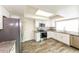Bright kitchen with stainless steel appliances, granite countertops, and white cabinetry at 5533 W Sunnyside Dr, Glendale, AZ 85304