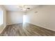 Bright living room with vaulted ceiling, ceiling fan, and stylish wood-look flooring at 5533 W Sunnyside Dr, Glendale, AZ 85304
