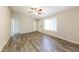 Spacious living room boasts a ceiling fan, natural light, and modern wood-look flooring at 5533 W Sunnyside Dr, Glendale, AZ 85304