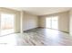 Bright living room with neutral walls, wood-look flooring, and sliding doors to the outside at 5533 W Sunnyside Dr, Glendale, AZ 85304