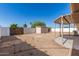 Large backyard featuring a storage shed, patio, and secure fencing under a clear blue sky at 6022 E Colby St, Mesa, AZ 85205