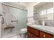 Updated bathroom with a marble walk-in shower, granite countertops, and wood vanity at 6022 E Colby St, Mesa, AZ 85205