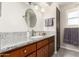 Charming bathroom featuring granite countertops, wood cabinets, and natural light at 6022 E Colby St, Mesa, AZ 85205