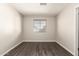 This spacious bedroom features wood floors, neutral walls, and bright natural light at 6022 E Colby St, Mesa, AZ 85205
