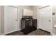 Well-lit laundry room features modern washer and dryer, overhead cabinets, and wood-look flooring at 6022 E Colby St, Mesa, AZ 85205