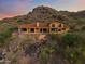 Desert home with an attractive pool, and a red tile roof set against a hillside backdrop at dusk at 6349 E Hummingbird Ln, Paradise Valley, AZ 85253