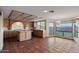 Eat-in kitchen with island, brick accents, and mountain views from the window-lined breakfast nook at 6349 E Hummingbird Ln, Paradise Valley, AZ 85253