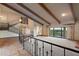 Spacious living room features exposed beams, a grand staircase and views from the large windows at 6349 E Hummingbird Ln, Paradise Valley, AZ 85253