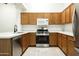 Modern kitchen featuring stainless steel appliances, white countertops, and stylish wood cabinets at 64 N 63Rd N St # 33, Mesa, AZ 85205