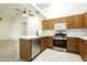 Well-lit kitchen with stainless steel appliances, white countertops, and wood cabinets at 64 N 63Rd N St # 33, Mesa, AZ 85205