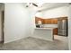 Open-concept kitchen with modern countertops, stainless steel appliances, and light wood cabinets at 64 N 63Rd N St # 33, Mesa, AZ 85205