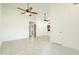 Open living area with vaulted ceilings, light-colored wood-look floors, and a view to the kitchen at 64 N 63Rd N St # 33, Mesa, AZ 85205