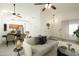 Open-concept living room with neutral decor, dining area, and light wood floors at 64 N 63Rd N St # 33, Mesa, AZ 85205