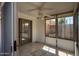 Enclosed sunroom with tile flooring and fan providing an inviting and relaxing space at 64 N 63Rd N St # 33, Mesa, AZ 85205