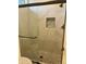 Bathroom features a shower with tile surround, a pebble floor and a built-in shelf at 7052 E Kessler Ave, Mesa, AZ 85209