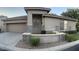 Inviting single-story home featuring stone accents, a two car garage, and desert landscaping at 7052 E Kessler Ave, Mesa, AZ 85209