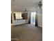 Open-concept living space with kitchen view and carpet flooring at 7052 E Kessler Ave, Mesa, AZ 85209